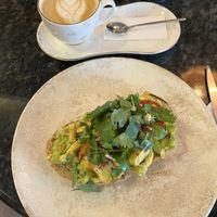 avo toast with scrambled tofu & a cappuchino  at Biofilia - Botánica Coffee House in La Paz
