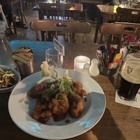 Vegan cauliflower wings with chips, a side salad, and a pint of Guinness    at Dolan's Pub and Restaurant in Limerick