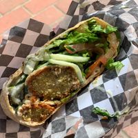 Falafel wrap. Perfectly seasoned falafel with lettuce, cucumbers and pickles with sauce.  at Stillfood Bistro in Salmon Arm