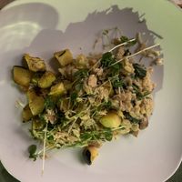 Risotto - Rice, cremini mushrooms, spinach in truffled cashew cream w/ roasted carrots, turnips & a pea shoot, vegan Parmesan & black pepper almond salad  at Fiction Kitchen in Raleigh