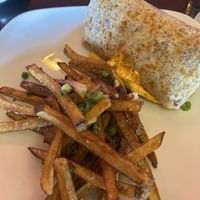 Special gluten free burrito with vegan popcorn chicken, cheese, veggies and special sauce.  House made pickle dipped potato fries.  at Fiction Kitchen in Raleigh