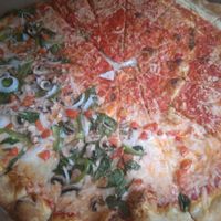 Half happy vegan and half Margherita at Tony's Pizza in Flagler Beach