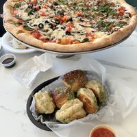 Large 1/2 vegan delight, 1/2 balsamic mushroom, both with vegan cheese and heavy garlic. Half dozen vegan garlic knots with marinara ( elves ate some before I got the picture).   at Tony's Pizza in Flagler Beach