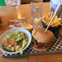 Vegan mozzarella crispy chkn burger with fries and side salad + an aperol spritz.  at Pura Vida Vegan Tacos in Antwerpen