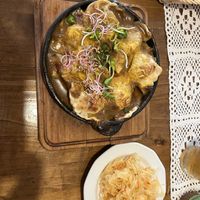 oven backed brokkoli pierogi with mushroom sauce and vegan cheese   at Pod Przykrywką in Wroclaw