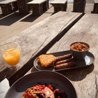Pancakes with bis off sauce, frozen berries and americano with oat milk plus vegan sausage, hash browns and beans with glass of OJ 😋 what a treat.  at North Sea Observatory in Chapel St Leonards