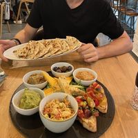 Starter sharing platter for 2 ❤️ (includes: hummus, baba ganoush, godly olives, mashed avocado, smoked tofu, cheese, unknown chunky dip, pita & bruschetta)  at Vegan Garden Budapest in Budapest