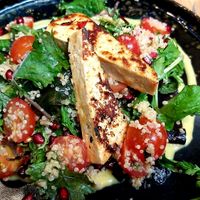 Quinoa Salad with pomegranate, mango dressing and grilled tofu marinated in sweet chili at Vegan Garden Budapest in Budapest