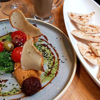 Hummus with tomatoes, home made pita bread and green pea balls at Vegan Garden Budapest in Budapest
