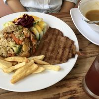 Paella w broccoli & meaty chunks, salad w creamy citrus dressing, quinoa meat w hammy flavors, carrot soup, hibiscus tea = happily stuffed! at Govinda's in Santa Marta