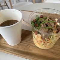 Cold Americano with oat mylk and a pad thai salad.   at Wild & The Moon - Ave de Champs Elysées in Paris