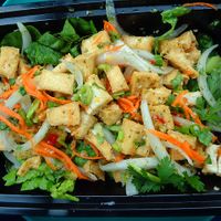 Larb Tofu from vegan menu, medium spice level, to go. Fried tofu cubes, lettuce, onions, carrots, lime juice, cilantro, chili. Came with white sticky rice. I am a fairly hearty eater and found it to be filling, even after giving the onions away, lol. at Sand Pebbles in Aurora