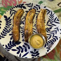 Sweet and spicy Plantains. Plantains themselves are great but thos were kinda dry and I didn‘t like the cheese sauce.  at Varuna Plant-Based Food & Juice Bar in Manuel Antonio