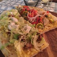 “Pinsa” (I think) you and me. Sharing dish with tuna and tomato or vegan sausage and cheese.  at Raparossa  in Pezze Di Greco