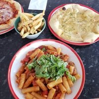 Vegan mozzarella and red onion pizza, fries, vegan garlic bread and red pepper, chilli and garlic pasta at Frankie & Benny's - Trafford Centre in Manchester