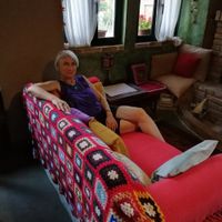 Reclining on the comfy sofa by the fire after dinner. at Lucciola Organic Bistro in Corfu