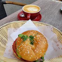 Vegan bagel and oatmilk latte at Coyote Coffee & Deli in Budapest