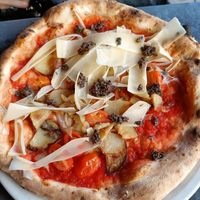 Vegan special, with potatoes, olive tapenade and baby tomatoes at Franco Manca - Chiswick in West London