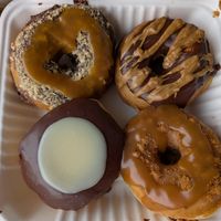 Boston cream, chocolate espresso, biscoff caramel, and chocolate caramel coconut at Dough House Vegan Donuts in Black Mountain
