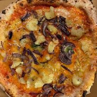 TARTUFO pizza with vegan option. (White pizza with vegan mozzarella, mushrooms, Icelandic potatoes, truffle oil, sea salt and basil) at Flatey Pizza in Reykjavik