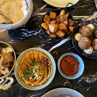 Cawliflower, muhammara, bread, potatoes with harissa, falafel  at Das Peace in Hamburg
