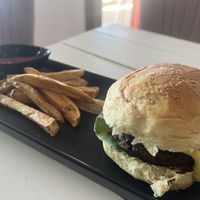 Homemade bean burger patty with cashew cheese, avo, caramelized onions with freshly cut fries  at Seawiches Lounge Bar in Roatan