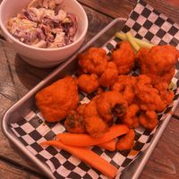 Sassy slaw and Buffalo cauli wings (all under an awkwardly orange patio tent top)   at Cornbread Cafe in Eugene