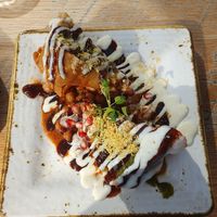 VEGAN SAMOSA CHAAT: Punjabi filo pastry stuffed with vegetables on a bed of chickpeas, Mint, tamarind & vegan yogurt at Delhi House Cafe in Manchester