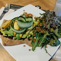 Sweet crêpe with fried beans and lentils, avocado, sautéed tofu, rocket, etc. And sour sop water shake. All vegan. at Crepes & Waffles in Medellin