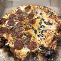 Vegan Pizza. We got half vegan pepperoni, half vegan sausage and all over mushrooms.   at Uncle Gino's Pizzeria in Temecula