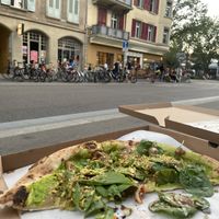 Eating the pizza across the street or on the square next to Da Nino  at da Nino in Bern