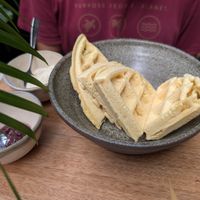 Yuca waffles served with a teaspoon of jam and cashew cream at W h o l l y in Medellin