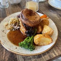 Sage & onion sausage plait with veg, roast potatoes, Yorkshire pud and gravy  at Huggers in Norwich
