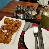 Onion Pakora, dips (mint, tamarind, coconut, and spicy I don't know what), and a lemon mint juice at Harbour Kitchen in Zanzibar