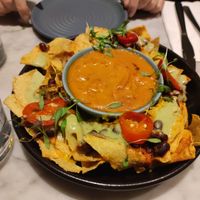 Shared starter. Nachos. Very tasty - huge bowl of sauce for quantity of chips. at Mildreds - Covent Garden in London