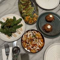 Taste of Mildred’s: Za’atar padron peppers, Kim chi gyoza, arancini rosso, harissa patatas bravas 🤤   at Mildreds - Covent Garden in London
