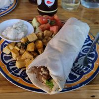 Falafel Wrap in the Combo, medio ensalada de tomates salad, medio papas at Le Coq in Playas Del Coco