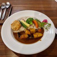 Curry with fruits and vegetables and a patato croquet at Sustaina in Bangkok