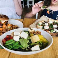 Vegan double cheeseburger, kale salad with grilled tofu, and spinach cashew-ricotta pizza. So delicious! at True Food Kitchen in Santa Monica