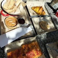 Cherry croissant, cookie, bread peanut butter and jam, tomato pizza at Qcorner in Forli