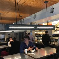 Tables inside (notice: bathroom for customers). at Chipotle - 55th and 3rd in New York City