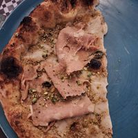 Half of pistachio pizza - we asked to share it in two people at Assaje in Trieste