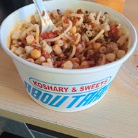 Koshuri with sauces and packaging at Abu Tarek in Cairo