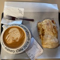 Hot oat latte and tomato marinade ciabatta  at Flour Artisan Bakery in Seoul
