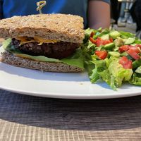 Signature Burger with house salad   at Elysian Plant Based Kitchen Bar in Limassol