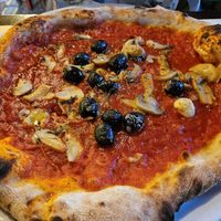 Pizza marinara with added olives and mushroom at Bella Napoli in Orzinuovi