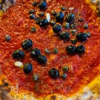 Pizza marinara with added olives and capers at Bella Napoli in Orzinuovi