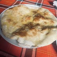Turkish flatbread includes sesame seeds and melted butter (vegan available - ask for no butter).  at Sunny's in Borovets