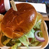 Really good fried seitan cutlet, tasty sauce, piled with lettuce, pickles and onions, on a big brioche bun.   at Vegan Grill - St Marks in New York City