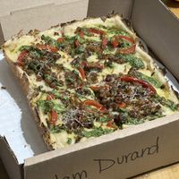 Vegan special! Detroit style pizza with NUMU vegan mozzarella, Impossible sausage, roasted red peppers, arugula pesto, shallots and vegan parm🥰  at Peels On Wheels in Rochester